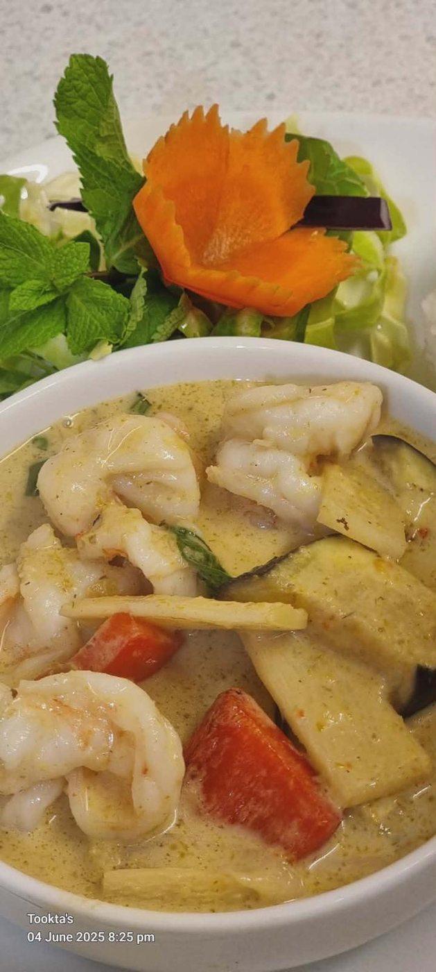 Green curry with fresh seafood — prawns, fish and bamboo in fragrant coconut broth